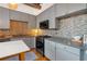 Modern kitchen with gray cabinets and a tile backsplash at 660 Glen Iris Ne Dr # 204, Atlanta, GA 30308