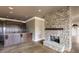 Basement with stone fireplace and wet bar at 1000 Leadenhall St, Alpharetta, GA 30022