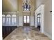 Grand two-story entryway with tile floors and chandelier at 1000 Leadenhall St, Alpharetta, GA 30022