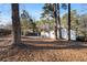 View of the spacious backyard, mature trees, and detached garage, offering lots of privacy at 1303 Rock Springs St, Forest Park, GA 30297