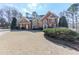 Traditional brick home with a well-manicured lawn and blue front door at 1594 Stoddard Nw Ct, Kennesaw, GA 30152