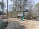 Wooden playhouse with slide and swing set in the backyard, perfect for outdoor fun at 1594 Stoddard Nw Ct, Kennesaw, GA 30152