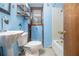 Bathroom with a tub, pedestal sink, and blue walls at 170 Pebble Path, Douglasville, GA 30134