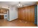 Simple dining area with wood paneling and kitchen view at 170 Pebble Path, Douglasville, GA 30134