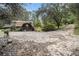 Gravel driveway leading to a rustic home with wooded backdrop at 170 Pebble Path, Douglasville, GA 30134