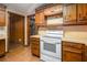 Kitchen with wood cabinets and white appliances at 170 Pebble Path, Douglasville, GA 30134