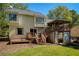 Back exterior of the house featuring a multi-level deck and well manicured lawn at 3956 Carriage Gate Dr, Duluth, GA 30096