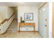 Welcoming foyer featuring tile floors, a wooden console table, and access to a carpeted staircase at 3956 Carriage Gate Dr, Duluth, GA 30096