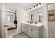 Double vanity bathroom with gray cabinets and a large mirror, view of bedroom at 12 Jacobs Farm Ln # 6, Lawrenceville, GA 30043