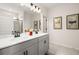 Double vanity bathroom with gray cabinets and a large mirror at 12 Jacobs Farm Ln # 6, Lawrenceville, GA 30043