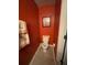 Small bathroom with orange walls, toilet and single sink at 331 Overlook Turn Northwest, Conyers, GA 30012