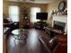 Living room featuring hardwood floors, fireplace, and leather furniture at 331 Overlook Turn Northwest, Conyers, GA 30012