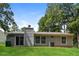 Gray house exterior with sliding glass doors opening to a patio and grassy yard at 5377 Martins Crossing Rd, Stone Mountain, GA 30088