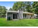 Gray house exterior with sliding glass doors opening to a patio and grassy yard at 5377 Martins Crossing Rd, Stone Mountain, GA 30088