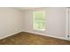 Bright bedroom featuring wood-look tile flooring and large window at 5377 Martins Crossing Rd, Stone Mountain, GA 30088