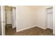 Bedroom with wood-look tile floors and access to hallway and closet at 5377 Martins Crossing Rd, Stone Mountain, GA 30088