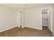 Well-lit bedroom with wood-look tile floors and access to bathroom and closet at 5377 Martins Crossing Rd, Stone Mountain, GA 30088