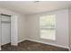 Simple bedroom with tile floor, closet and window at 5377 Martins Crossing Rd, Stone Mountain, GA 30088