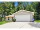 Ranch style home with attached garage and manicured lawn at 5377 Martins Crossing Rd, Stone Mountain, GA 30088