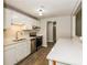 Kitchen with white cabinets, stainless steel appliances and island at 5377 Martins Crossing Rd, Stone Mountain, GA 30088