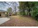 Expansive backyard featuring mature trees, a patio area, and lush green space at 2980 Laguna Dr, Decatur, GA 30032