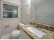 Bathroom featuring granite countertops, a white cabinet, modern fixtures, and a window at 2980 Laguna Dr, Decatur, GA 30032