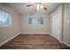 Cozy bedroom with wood-look floors, a ceiling fan, and ample natural light from the windows at 2980 Laguna Dr, Decatur, GA 30032