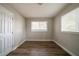 Bedroom featuring hardwood floors and natural light from two windows at 2980 Laguna Dr, Decatur, GA 30032