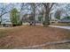 Charming ranch-style home with a red door and large front yard, ready for new landscaping at 2980 Laguna Dr, Decatur, GA 30032