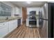 Updated kitchen with stainless steel appliances, granite countertops, and white cabinetry at 2980 Laguna Dr, Decatur, GA 30032