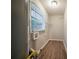 Well-lit laundry room featuring wood flooring, storage options, and a window for natural light at 2980 Laguna Dr, Decatur, GA 30032