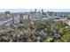 Aerial view of homes surrounded by lush greenery with a city skyline in the background at 1031 Eulalia Ne Rd, Atlanta, GA 30319