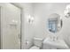 Well-lit bathroom with tiled shower and large circular mirror at 1031 Eulalia Ne Rd, Atlanta, GA 30319