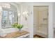 Bathroom view showcasing glass shower with bench, marble countertop, and wainscoting at 1031 Eulalia Ne Rd, Atlanta, GA 30319