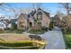 Charming brick home featuring manicured landscaping, a stone walkway, and an attached porte-cochere at 1031 Eulalia Ne Rd, Atlanta, GA 30319