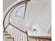 View up the curved staircase showcasing white trim, dark wood railing, and ceiling details at 1031 Eulalia Ne Rd, Atlanta, GA 30319