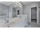 Modern bathroom with dual sinks, a large mirror, and walk-in closet at 287 Jenna Ln, Dallas, GA 30157