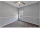 This bedroom offers neutral-colored walls, a ceiling fan, carpeted floors, and a window at 287 Jenna Ln, Dallas, GA 30157