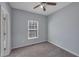 This bedroom features neutral walls, carpeting, a ceiling fan, and a window that provides natural light at 287 Jenna Ln, Dallas, GA 30157