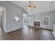 Inviting living room featuring a cozy fireplace, hardwood floors, modern lighting, and open layout at 287 Jenna Ln, Dallas, GA 30157