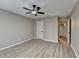 This bedroom features neutral walls, ceiling fan, and light gray flooring at 4815 Diggers Way, Sugar Hill, GA 30518