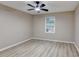 This bedroom features neutral walls, ceiling fan, and a window that provides natural light at 4815 Diggers Way, Sugar Hill, GA 30518