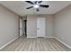 Spacious bedroom featuring neutral walls, updated flooring, and a ceiling fan at 4815 Diggers Way, Sugar Hill, GA 30518