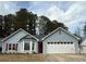 Charming single-story home with a two-car garage, red door and red shutters at 4815 Diggers Way, Sugar Hill, GA 30518