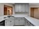 Bright kitchen showcasing a stainless steel sink, white countertops, and view of the living space at 4815 Diggers Way, Sugar Hill, GA 30518