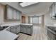 Spacious kitchen with gray cabinets, white countertops, and light-wood floors extending to the living area at 4815 Diggers Way, Sugar Hill, GA 30518