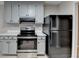 Updated kitchen with stainless steel appliances, gray cabinets, and modern countertops at 4815 Diggers Way, Sugar Hill, GA 30518