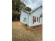 Side yard of home with vinyl siding, red shutters, and tidy landscaping at 4815 Diggers Way, Sugar Hill, GA 30518