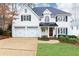 Charming two-story home with a well-manicured lawn, black shutters, and a three-car garage at 1069 Saint James Ne Xing, Atlanta, GA 30319