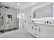 Modern bathroom with double vanity, marble shower, and LED mirror at 206 Hunters Ln, Powder Springs, GA 30127